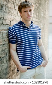 Young Handsome Man In Polo Shirt Relaxing.