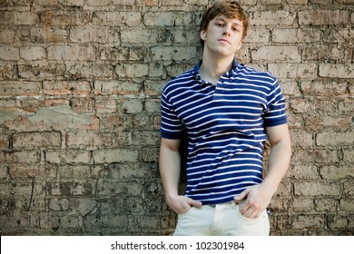 Young Handsome Man In Polo Shirt Relaxing.