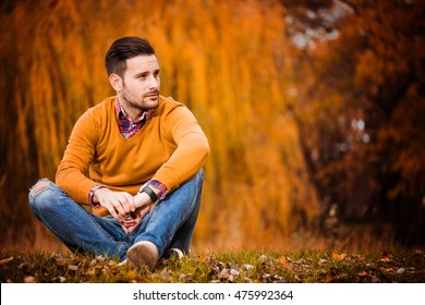 Young Handsome Man Posing In Autumn Park.