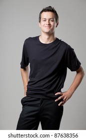 Young Handsome Man Posing In Black Shirt.