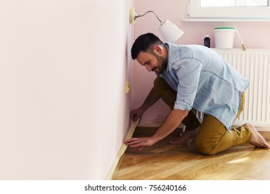 Young Handsome Man Is Preparing To Paint Wall In The House