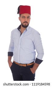 young handsome man putting hands in pockets and wearing tarboosh , isolated in white background