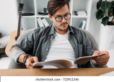 Young Handsome Man Reading Magazine