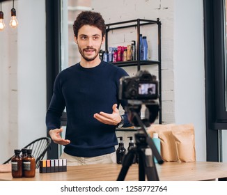 Young Handsome Man Is Showing Cosmetic To The Camera. Hobby, Blogger, Interest. Close Up Photo. Male Beauty Blogger