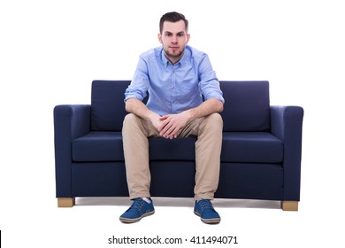 young handsome man sitting on sofa isolated on white background