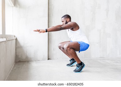 Young Handsome Man Is Squatting