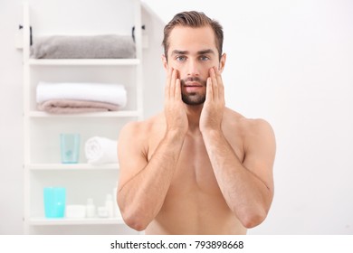 Young Handsome Man Standing In Bathroom