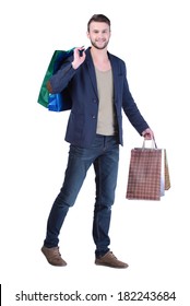 Young Handsome Man In Suit With Shopping Bags. Isolated On White Background