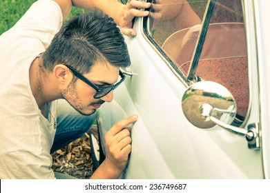 Young Handsome Man With Sunglasses Inspecting A Vintage Car Body At Second Hand Trade - Passion And Transportation Lifestyle Of A Retro Classic Vehicles Collector