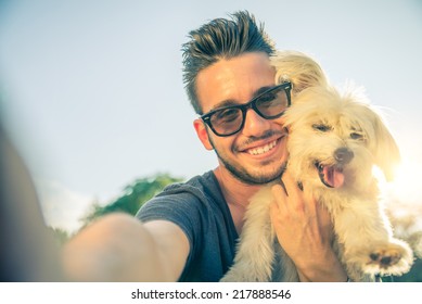 Young Handsome Man Taking A Selfie With His Dog