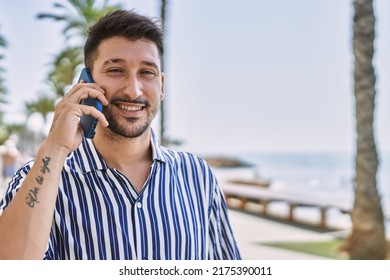 Young Handsome Man Talking To The Phone By The Sea