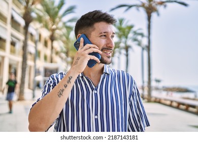 Young Handsome Man Talking To The Phone By The Sea