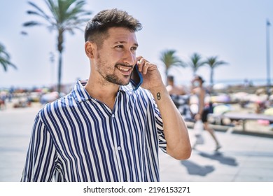 Young Handsome Man Talking To The Phone By The Sea