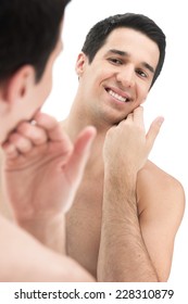 Young Handsome Man Touching His Smooth Face After Shaving. Close-up Portrait Of Clean-shaven Male Face With Toothy Smile 