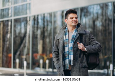 Young handsome man traveller using phone outside