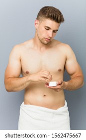 Young Handsome Man Using Hair Wax