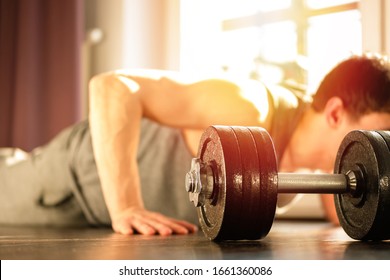 Young Handsome Man Using Phone While Having Exercise Break In Gym. Guy Using Smartphone After The Daily Training.