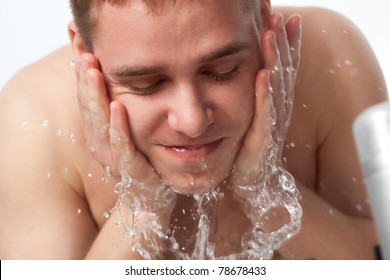 Young Handsome Man Washing His Face