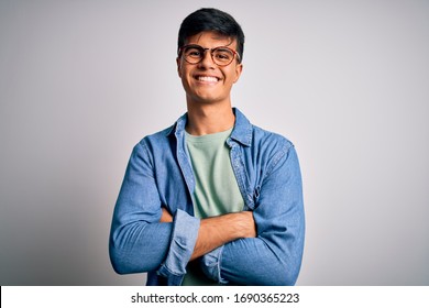 Young Handsome Man Wearing Casual Shirt And Glasses Over Isolated White Background Happy Face Smiling With Crossed Arms Looking At The Camera. Positive Person.