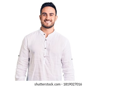 Young handsome man wearing casual clothes looking positive and happy standing and smiling with a confident smile showing teeth 
