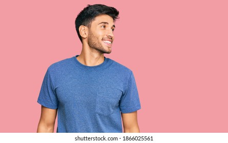 Young Handsome Man Wearing Casual Clothes Looking Away To Side With Smile On Face, Natural Expression. Laughing Confident. 