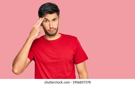 Young Handsome Man Wearing Casual Red Tshirt Shooting And Killing Oneself Pointing Hand And Fingers To Head Like Gun, Suicide Gesture. 