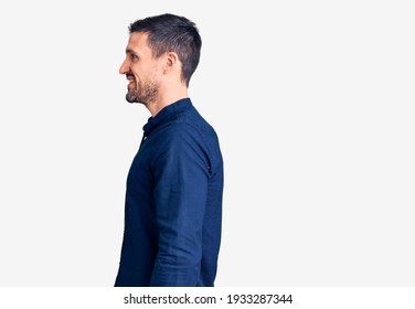 Young Handsome Man Wearing Casual Shirt Looking To Side, Relax Profile Pose With Natural Face And Confident Smile. 