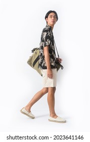 Young Handsome Man Wearing Casual Summer Shirt With White Pants Sitting In Studio,

