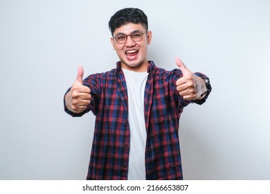 Young handsome man wearing casual shirt over white background approving doing positive gesture with hand, thumbs up smiling and happy for success. Winner gesture. - Shutterstock ID 2166653807