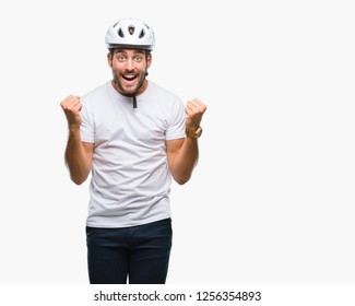 Young handsome man wearing cyclist safety helmet over isolated background celebrating surprised and amazed for success with arms raised and open eyes. Winner concept. - Powered by Shutterstock