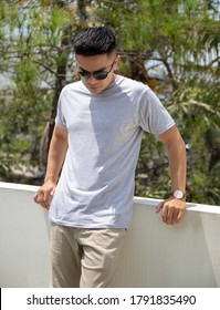 Young Handsome Man Wearing Heather Grey T Shirt Was Posing In Outdoor