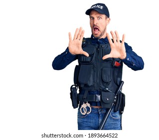 Young Handsome Man Wearing Police Uniform Afraid And Terrified With Fear Expression Stop Gesture With Hands, Shouting In Shock. Panic Concept. 