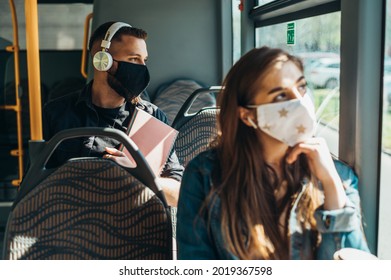 Young handsome man wearing protective mask while riding a bus during covid19 world pandemic