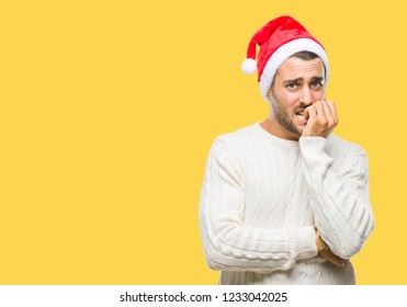 Young handsome man wearing santa claus hat over isolated background looking stressed and nervous with hands on mouth biting nails. Anxiety problem. - Powered by Shutterstock