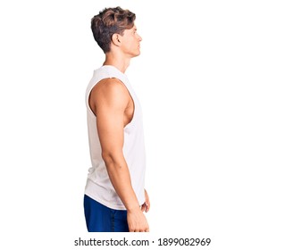 Young handsome man wearing sleveeless t shirt looking to side, relax profile pose with natural face with confident smile.  - Powered by Shutterstock