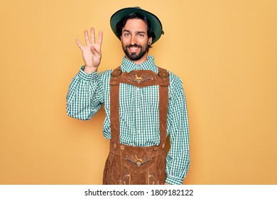 Young handsome man wearing tratidional german octoberfest custome for Germany festival showing and pointing up with fingers number four while smiling confident and happy. - Shutterstock ID 1809182122