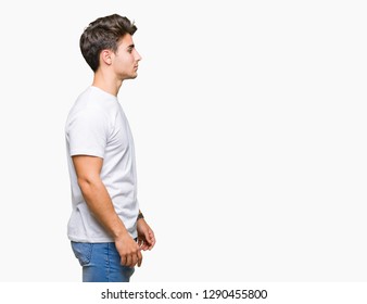 Young Handsome Man Wearing White T-shirt Over Isolated Background Looking To Side, Relax Profile Pose With Natural Face With Confident Smile.