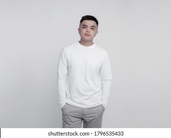 Young handsome man wearing white long sleeve t shirt with mockup concept