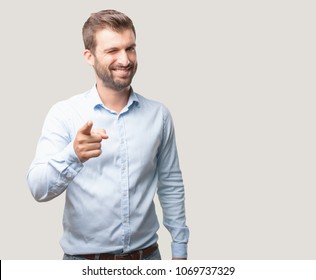 Young Handsome Man Winking Eye Pose Wearing Blue T Shirt . Person Isolated Against Monochrome Background