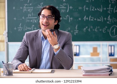 Young handsome math teacher in classroom  - Powered by Shutterstock