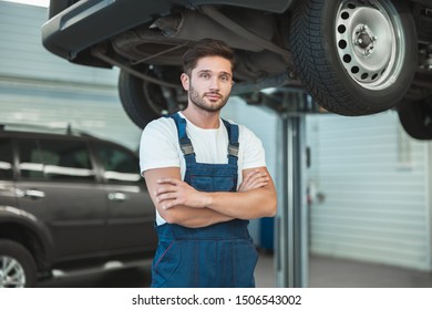 Young Handsome Mechanic Working In Car Service Department