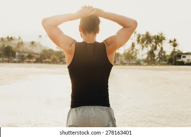 Young Handsome Men Relaxed At Sunny Day On Sunset Beach,after Serf ,wear Wetsuit And Surf Shorts,Cool Man With Beard.Watching The Sunset On Palm Beach In California.Tan Fit Trainer,summer Mens Fashion