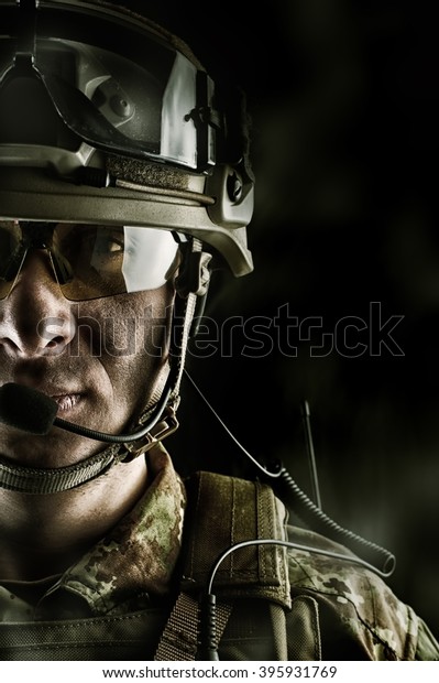 Young handsome military man in
italian camouflage wearing helmet, glasses and radio
set
	
