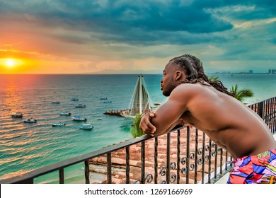 Young, handsome, muscular, shirtless African American man enjoying the sunset in Puerto Vallarta, Mexico.