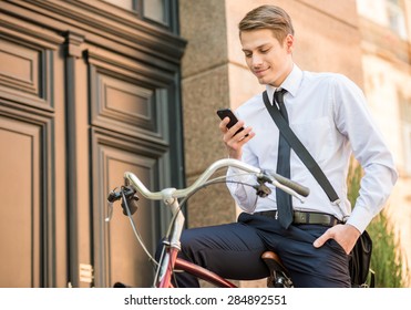 Young Handsome Office Worker Going To Work On His Bicycle. Healthy Lifestyle Concept.