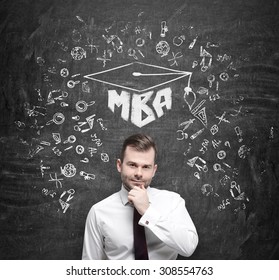 Young handsome professional is thinking about MBA degree. Drawn a graduation hat and the range of educational icons on the concrete background . - Powered by Shutterstock