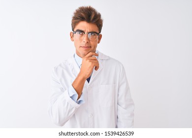 Young Handsome Sciencist Man Wearing Glasses And Coat Over Isolated White Background Thinking Worried About A Question, Concerned And Nervous With Hand On Chin