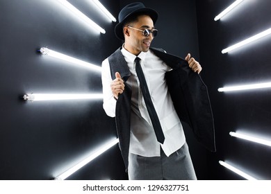 Young Handsome Smiling Hipster Black Man In Retro Vintage Style Suit Dancing Hip Hop In Disco Night Club, Having Fun