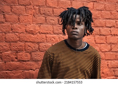 Young handsome stylish african guy, man,portrait. Natural hair dreadlocks. District,street with art graffiti city culture. American skateboarder with skateboard. Millennial,zoomer,generation Y,Z. - Powered by Shutterstock