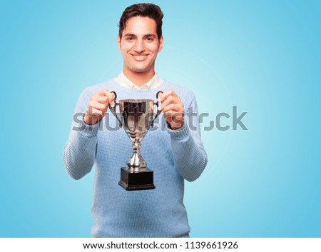 young handsome tanned man with a trophy